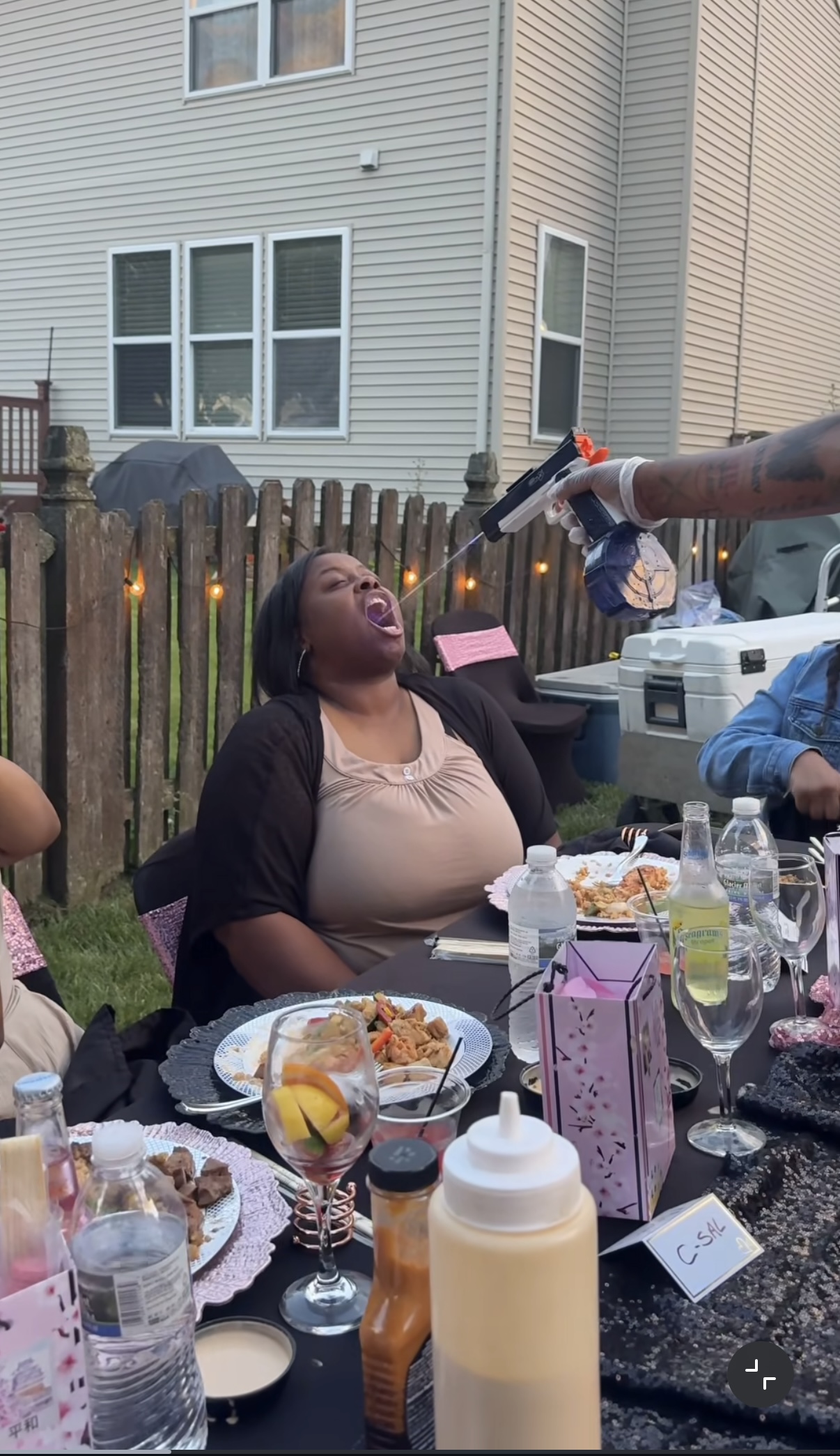 A playful moment at an outdoor hibachi gathering